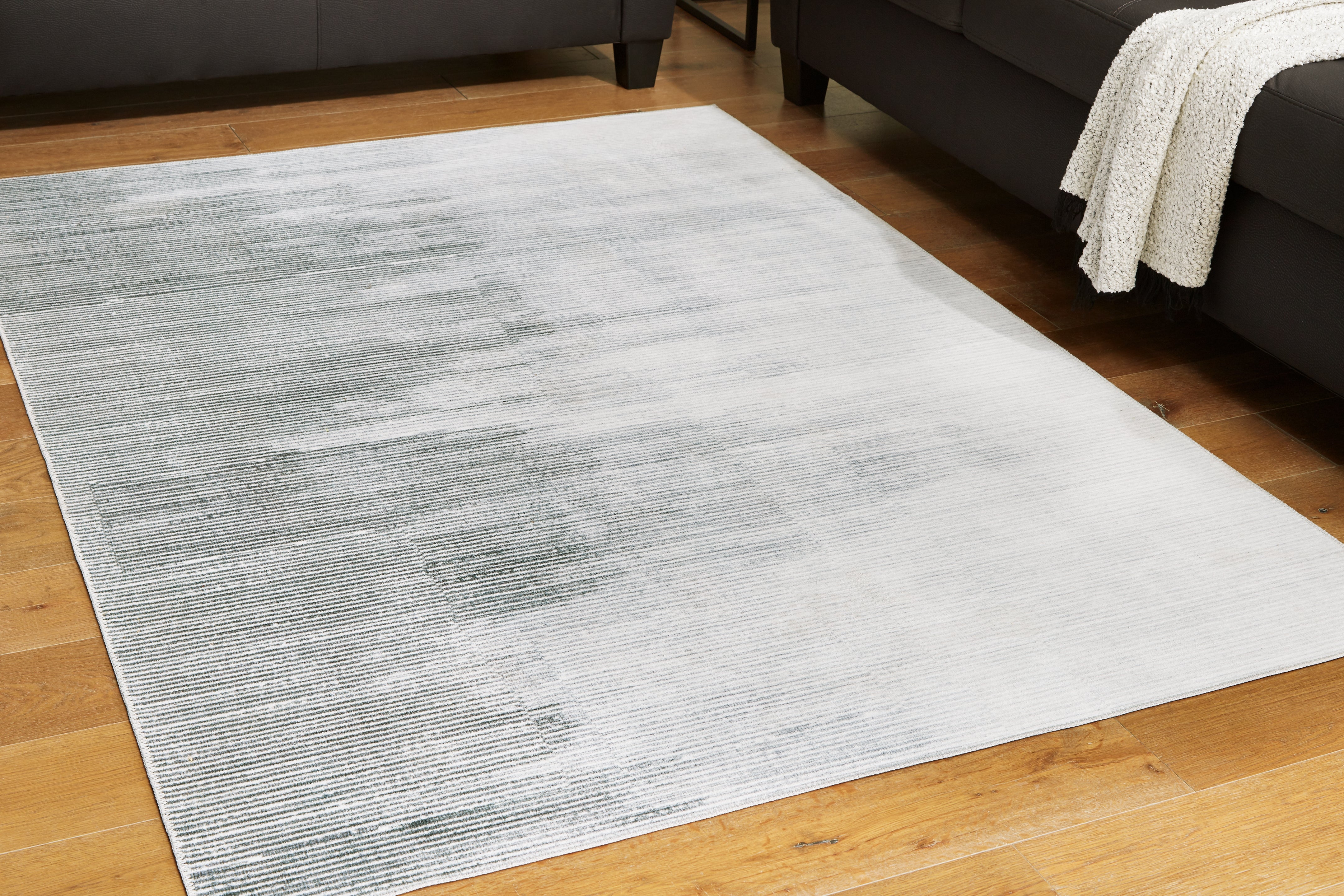 Orleans Furniture - Ashley Furniture - Milset Rug - 5'1" x 6'10" Washable Rug / Black/White/Gray - R406252